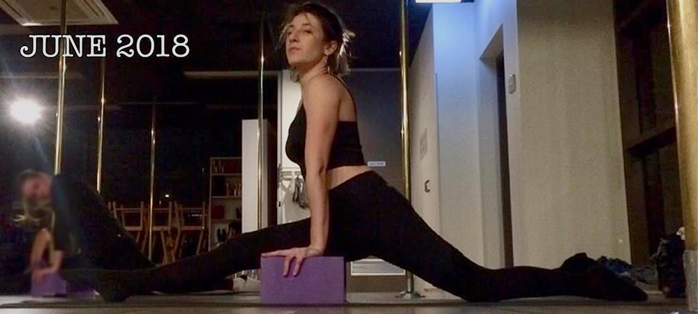 Beginner dancer stretching front splits on a yoga mat at the start of her dance journey