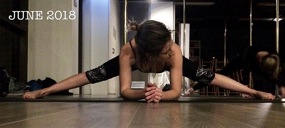 Beginner dancer stretching middle splits at a pole studio at the start of her dance journey