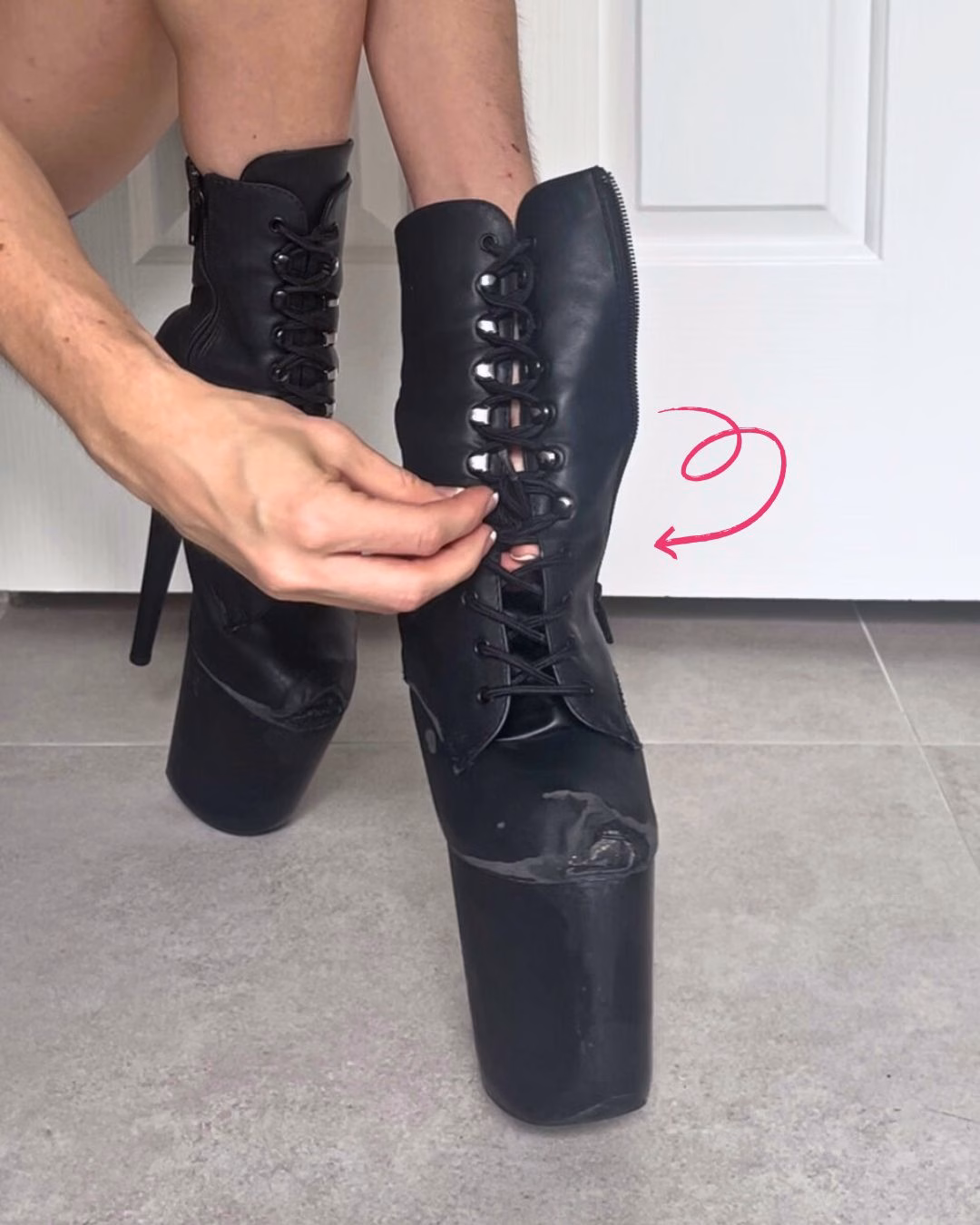 hands demonstrating how to tuck laces of a pole dance boot underneath the cross lacing.